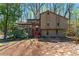 Exterior of two-story home with wood paneling and wooded front yard at 3292 Holly Mill Ct, Marietta, GA 30062