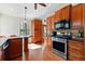 Well-lit kitchen with wooden cabinets, stainless steel appliances, and eat-in breakfast bar at 3292 Holly Mill Ct, Marietta, GA 30062