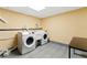 Functional laundry room area with tile floors, appliances and simple finishes at 3292 Holly Mill Ct, Marietta, GA 30062