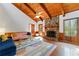 Cozy living room featuring a stone fireplace, wood-beamed ceiling, and large windows at 3292 Holly Mill Ct, Marietta, GA 30062