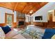 Open living room featuring stone fireplace, wood-paneled walls, and vaulted ceilings at 3292 Holly Mill Ct, Marietta, GA 30062