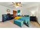 Comfortable main bedroom with neutral carpet, dark wood furniture, and a ceiling fan at 3292 Holly Mill Ct, Marietta, GA 30062