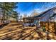 The backyard features a screened-in porch, mature trees, and a wooden fence at 409 Hunting Ridge Way, Ellenwood, GA 30294
