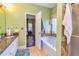 The primary bathroom features a soaking tub and granite countertops at 409 Hunting Ridge Way, Ellenwood, GA 30294