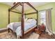 This bedroom features a beautiful four poster bed and wooden floors at 409 Hunting Ridge Way, Ellenwood, GA 30294