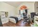 Comfortable bedroom with a unique window, a desk for work, and stylish decor accents at 409 Hunting Ridge Way, Ellenwood, GA 30294
