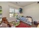 Bright bedroom featuring a large window, playful decor, and hardwood floors at 409 Hunting Ridge Way, Ellenwood, GA 30294