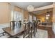 Open-concept dining room flows into a living area with fireplace, creating an inviting space for entertaining and relaxation at 409 Hunting Ridge Way, Ellenwood, GA 30294