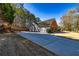 The exterior features a long driveway and a well maintained front yard at 409 Hunting Ridge Way, Ellenwood, GA 30294