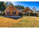 Charming brick home with manicured front yard and dark shutters at 409 Hunting Ridge Way, Ellenwood, GA 30294