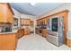Spacious kitchen featuring granite countertops, stainless steel appliances, and beautiful wood cabinetry at 409 Hunting Ridge Way, Ellenwood, GA 30294