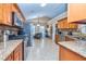 Open kitchen showcasing granite counters, stainless appliances, wood cabinets, and adjacent breakfast nook at 409 Hunting Ridge Way, Ellenwood, GA 30294