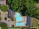 Aerial view of a community pool featuring ample lounging space and a separate lap pool surrounded by lush greenery at 4406 Kendall Way, Roswell, GA 30075