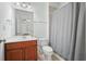 Full bathroom with cherry vanity and a shower/tub with curtain at 4406 Kendall Way, Roswell, GA 30075