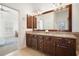 Bathroom featuring double vanity, large mirror, and access to the main bedroom at 4406 Kendall Way, Roswell, GA 30075