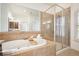 Serene bathroom featuring a soaking tub, shower with glass door, and tiled surround at 4406 Kendall Way, Roswell, GA 30075