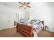 Bedroom featuring ceiling fan, television, carpet, and an ensuite bathroom at 4406 Kendall Way, Roswell, GA 30075