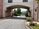 An elegant gated entrance leading to a private residence or community, framed by brickwork and lush greenery at 4406 Kendall Way, Roswell, GA 30075