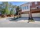Shot of a townhouse featuring a brick exterior, drive under garage, and balcony at 4406 Kendall Way, Roswell, GA 30075