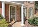 Close-up of front door, showing pillars and brickwork detail, plus nicely maintained surrounding shrubbery at 4406 Kendall Way, Roswell, GA 30075