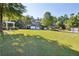 Expansive lawn area in front of a traditional brick home with a white pergola and mature trees at 4406 Kendall Way, Roswell, GA 30075