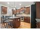 Spacious kitchen with dark wood cabinets, granite countertops, and an island with bar seating at 4406 Kendall Way, Roswell, GA 30075