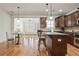 Open-concept kitchen with granite countertops, dark wood cabinets, and modern stainless steel appliances at 4406 Kendall Way, Roswell, GA 30075