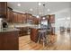 Open kitchen featuring wooden cabinets, granite countertops, and stainless steel appliances offers the perfect gathering space at 4406 Kendall Way, Roswell, GA 30075