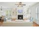 Bright living room with fireplace, built-in shelves, plantation shutters and hardwood flooring at 4406 Kendall Way, Roswell, GA 30075
