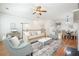Bright living room featuring hardwood floors, neutral furniture, a ceiling fan, and a dining table with chairs at 4406 Kendall Way, Roswell, GA 30075