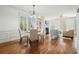 Open-concept living space includes a dining area, living room, and shuttered windows for natural light at 4406 Kendall Way, Roswell, GA 30075