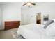 Bright main bedroom with ceiling fan, white walls, plush rug, and an ensuite bathroom for added convenience at 4406 Kendall Way, Roswell, GA 30075