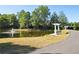 Scenic pond view with a fountain, lush trees, and a walking path with a bench and pergola at 4406 Kendall Way, Roswell, GA 30075