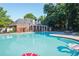 Large community pool with clear water, lounge chairs, and a fenced area, perfect for relaxation at 4406 Kendall Way, Roswell, GA 30075