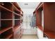 Spacious walk-in closet with custom shelving, drawers, and ample hanging space at 4406 Kendall Way, Roswell, GA 30075