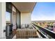 Cozy balcony with cushioned seating, a table, and a view of the surrounding trees at 2660 Peachtree Nw Rd # 26F, Atlanta, GA 30305