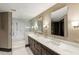 Bright bathroom featuring double sinks, marble countertop, and a glass enclosed shower at 2660 Peachtree Nw Rd # 26F, Atlanta, GA 30305