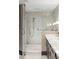 Modern bathroom showcasing a glass enclosed shower with marble walls and an accessible shower at 2660 Peachtree Nw Rd # 26F, Atlanta, GA 30305