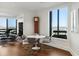 Bright dining area with a round table, modern chairs, and skyline views at 2660 Peachtree Nw Rd # 26F, Atlanta, GA 30305