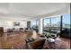Bright living room with city views from floor-to-ceiling windows and access to balcony at 2660 Peachtree Nw Rd # 26F, Atlanta, GA 30305