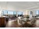 Bright living room and dining area feature hardwood floors and large windows with city views at 2660 Peachtree Nw Rd # 26F, Atlanta, GA 30305