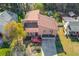 Aerial view of home featuring a manicured lawn, large driveway, and mature trees at 5494 Princeton Oaks Ln, Sugar Hill, GA 30518