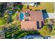Aerial view of house featuring a pool, green lawns, and a peaceful wooded backdrop at 5494 Princeton Oaks Ln, Sugar Hill, GA 30518