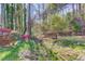 Backyard with small bridge, stone landscaping, and a peaceful, serene view at 5494 Princeton Oaks Ln, Sugar Hill, GA 30518