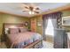 Bedroom with a ceiling fan, cozy window, and traditional decor at 5494 Princeton Oaks Ln, Sugar Hill, GA 30518