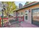 Cozy exterior with a red wood porch, metal bench, and quaint lamppost at 5494 Princeton Oaks Ln, Sugar Hill, GA 30518