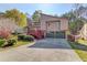 Inviting two-story home with a two-car garage, deck, and well-maintained landscaping at 5494 Princeton Oaks Ln, Sugar Hill, GA 30518