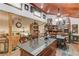 Open kitchen/dining area with granite island, wood cabinets, and overhead ceiling fan at 5494 Princeton Oaks Ln, Sugar Hill, GA 30518
