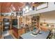 Inviting kitchen featuring a granite island, wood cabinetry, and an open dining area at 5494 Princeton Oaks Ln, Sugar Hill, GA 30518