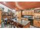 Spacious kitchen featuring granite countertops, wood cabinetry, and dining area at 5494 Princeton Oaks Ln, Sugar Hill, GA 30518